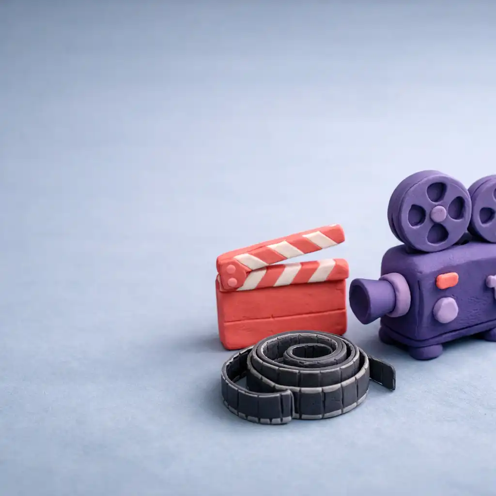 Miękka diorama z fioletowym projektorem filmowym i koralowym klapsem na studyjnym stole